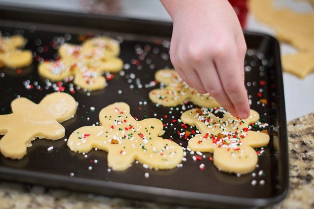 decorating cookies on a cookie tray