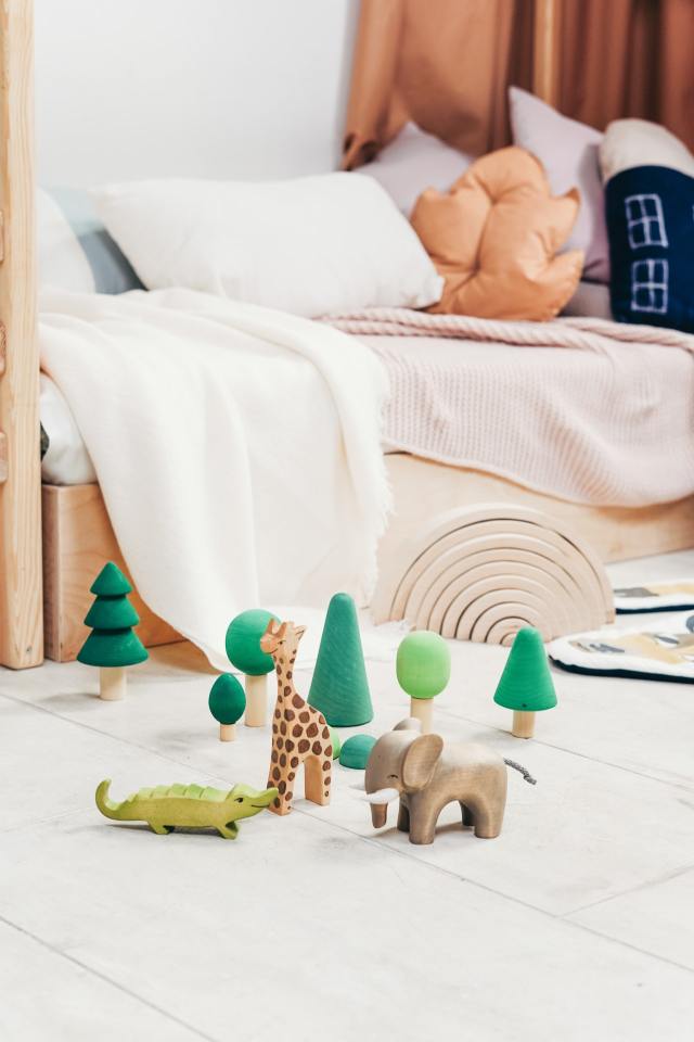 In a child's bedroom there are some animals set up for playtime. For beginning independent child's play you need to set up the scene for your kids.